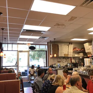 people sitting at tables in a restaurant