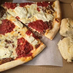 Slices of lasagna pizza with garlic knots