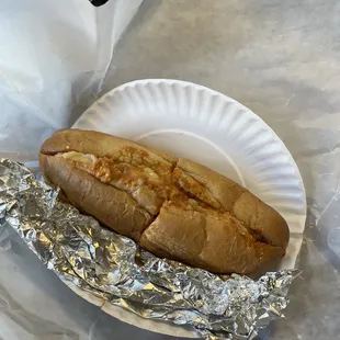 a hot dog on a paper plate