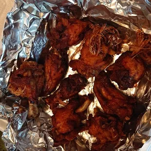 a tray of chicken wings and broccoli