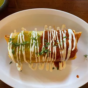 Steak chimichanga (with beans, cheese, and steak) topped with homemade red and green salsa &amp; sour cream.