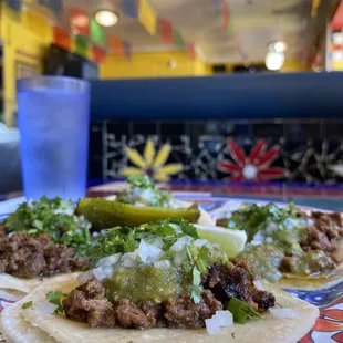 a plate of tacos and a glass of water