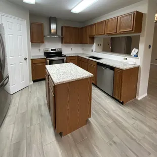 a kitchen with wood cabinets and stainless steel appliances