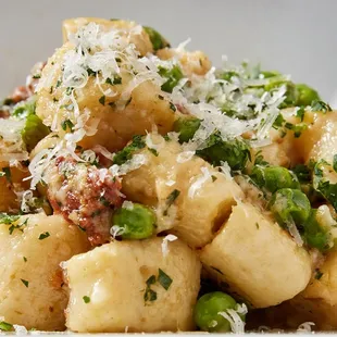 a pasta dish with peas and parmesan cheese