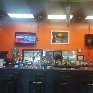 a bar with a television above it