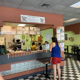 a woman ordering food at a restaurant