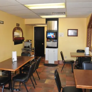 a dining area with tables and chairs