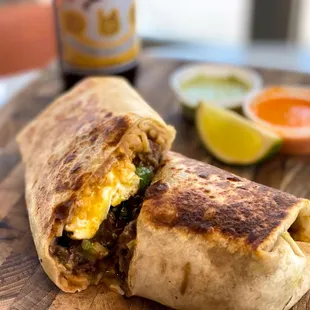 a burrito cut in half on a cutting board