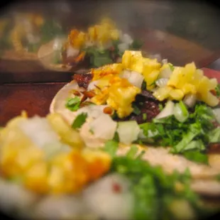 Pastor tacos made the traditional way! Get it with a little pineapple garnish, seriously each bite teleports you to Mexico.