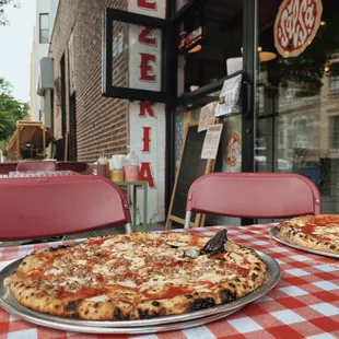 two pizzas on a table
