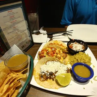 Chips and salsa basket (left) 3 taco plater From front to back: wild mushroom taco, crispy fish taco, citrus shrimp taco.