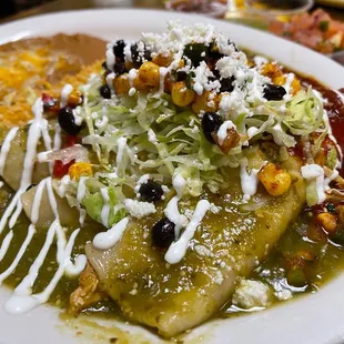 Delicious Chicken Enchiladas with half green and half red sauce.