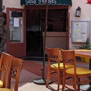 tables and chairs with umbrellas