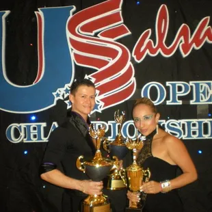 Directors John and Liz holding trophies for Top Dance Company and Top Teachers at the 2011 US Salsa Open Championships.