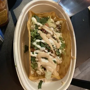 a taco in a styrofoam container