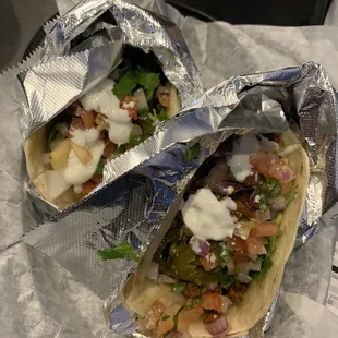 Lime shrimp (left) and El Pastor (Right), each on a flour tortilla, with cilantro/onions, jalapeños, sour cream, and Pico.