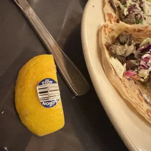 Lemon on my plate with sticker still on it
