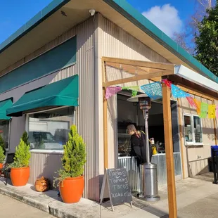 Outside and window to order. Cute!