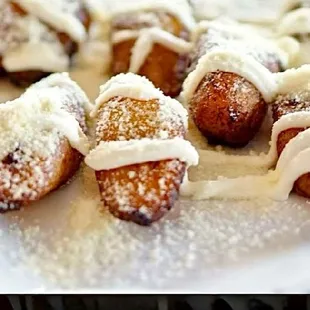 a plate of hot dogs covered in icing