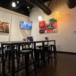 Inside, the bar tables with stools