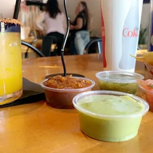 complimentary chips and variety of salsas with a mango margarita