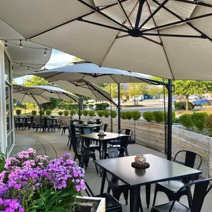 tables and chairs with umbrellas