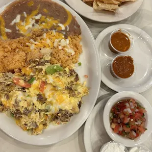 Machaca and egg, house salsa, picante, and sour cream, chips instead of toast,