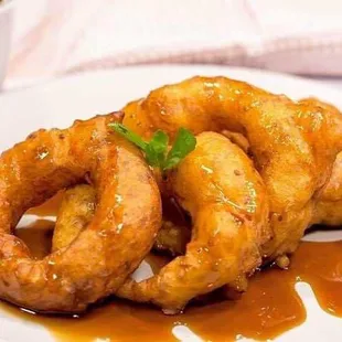 Picarones, traditional Peruvian donuts fig sauce on top