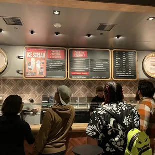 a group of people standing in front of a counter
