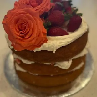 a cake with strawberries and roses
