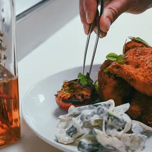 Whole Cornish game hen that is milk brined, buttermilk breaded &amp; deep fried. Served with cucumber salad &amp; chile &amp; herb infused honey.