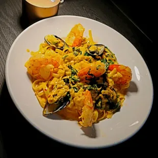 Fire Pasta - fettuccine with mussels, shrimp, clams, spinach &amp; basil in spicy sambal sauce.