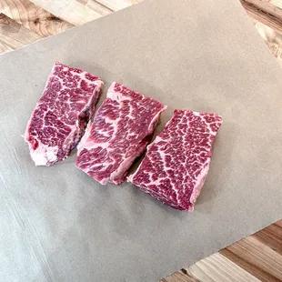 three pieces of beef on a piece of paper