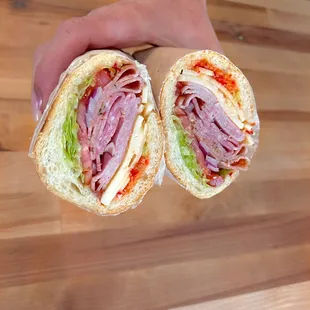 a person holding a sandwich