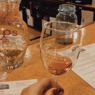 a hand holding a wine glass