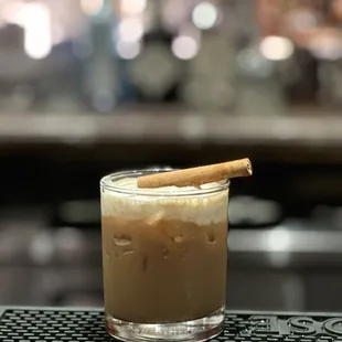 a drink with a cinnamon stick in it