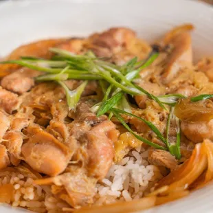 a bowl of rice with meat and vegetables