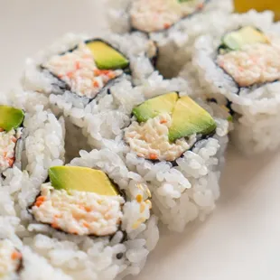 a plate of sushi with avocado