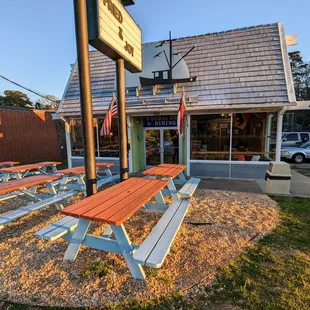 Outside. Storefront. Outdoor picnic table seating. They have an indoor dining room too.