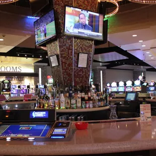 a casino bar with a large screen tv