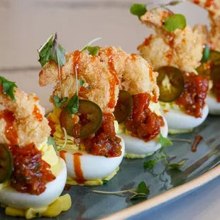 deviled eggs topped with pickled jalapenos