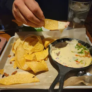 Traditional queso dip with chips.