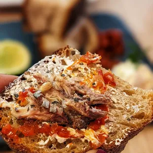 Here's a bite of the heavenly anchovies on bread with all the condiments! Cannot recommend it enough!