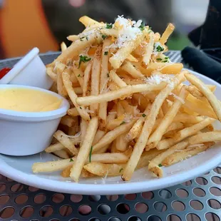 Truffle Fries - shoe string potatoes tossed with truffle infused oil, fin herbs, Pecorino-Romano &amp; house-made aioli dip