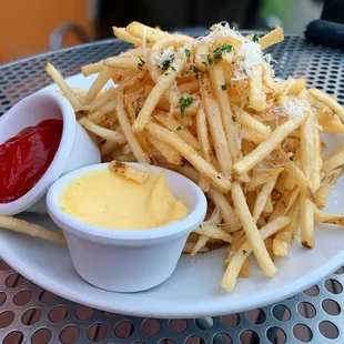 Truffle Fries - shoe string potatoes tossed with truffle infused oil, fin herbs, Pecorino-Romano &amp; house-made aioli dip