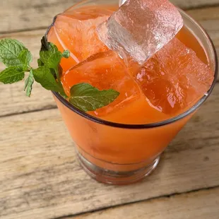 a drink with ice cubes and mint