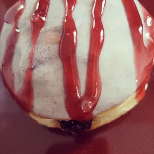 a donut drizzled with chocolate