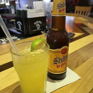 a glass of lemonade and a bottle of beer
