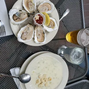a plate of oysters and a bowl of soup