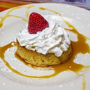 TRES LECHES CAKE - Sponge cake soaked in three full avored milks,
served with whipped cream and a fresh strawberry on top